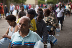 After Cape Town restricted water use in February to 13 gallons per day per person, city residents now wait in increasingly long lines to collect water from the city's natural springs. 