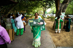 Women demonstrators protest a plan to to cut down more than 14,000 trees for a redevelopment project in New Delhi in June 2018.