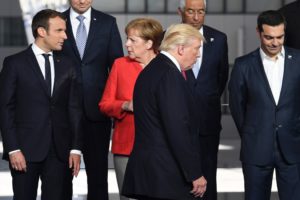 President Trump with French President Emmanuel Macron (left) and German Chancellor Angela Merkel at the NATO summit in Brussels last month.