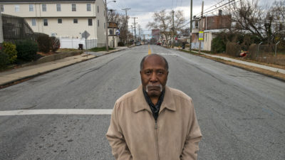Marvin Thomas, a longtime civic activist, stands at a Southbridge intersection that has flooded repeatedly in recent years.