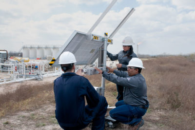 Dirk Richter (left), founder of Quanta3, inspects his company's methane detection system at a Statoil well pad in Karnes County, Texas.
