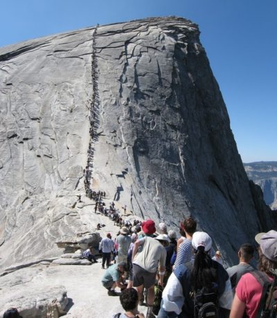 A crowd waits to ascend the Half Dome in Yosemite National Park.