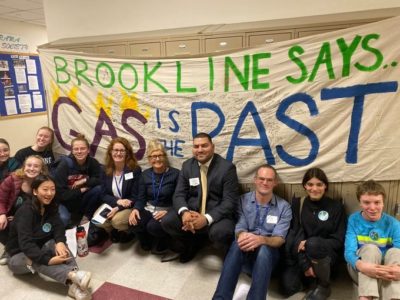 Advocates celebrate the passage of a gas ban in Brookline, Massachusetts last November.