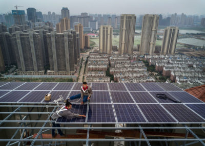 Workers install solar panels in Wuhan. China added 53 megawatts of new solar capacity in 2017.
 
  