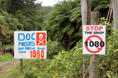 Signs opposing New Zealand's use of landscape-scale poisoning campaigns to eradicate non-native predators, such as rats and weasels.