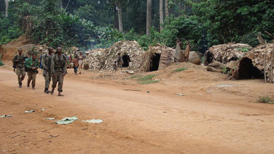 Eco-guards enter a Baka camp, preparing to conduct a raid.