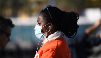 A woman watches the arrival of a U.S. Navy hospital ship in Los Angeles amid the coronavirus crisis last week.