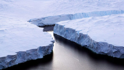 An iceberg (right) breaks off the Knox Coast in East Antarctica.