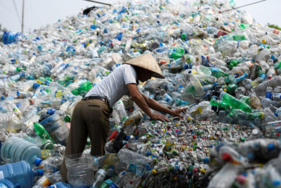 A worker sorts through plastic bottles at a waste facility in Vietnam. Other Asian countries have increased their waste imports in response to China's ban.