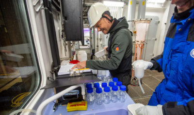 Oceanographer Colin Stedmon prepares water samples for acidification measurements aboard the Kronprins Haakon.