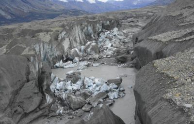 Recently collapsed ice blocks in the ice-walled canyon at the terminus of the Kaskawulsh Glacier. Increasing meltwater from the glacier has carved a new path, with water flow now heading west into the Gulf of Alaska rather than north into the Bering Sea.
