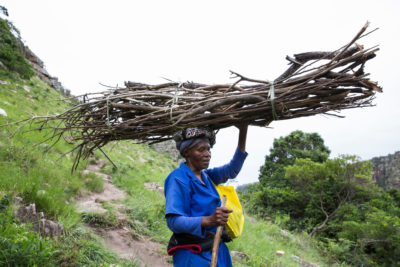 Alice Mbuthuma, whose daughter Nonhle is a leading opponent of the mining project, carries firewood after crossing the footbridge connecting Pondoland with Port Edward.