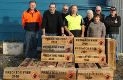 Volunteers for New Zealand's Predator Free by 2050 campaign in front of predator traps, which are available for the public to borrow. 