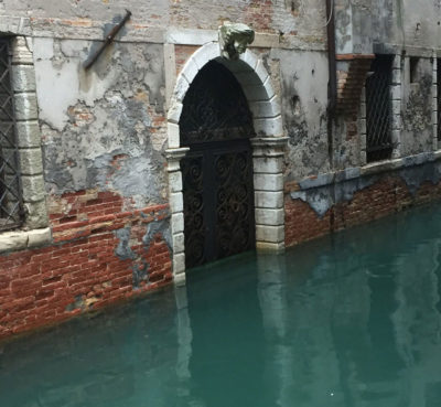 Frequent saltwater flooding is damaging Venice's structures, such as this building where plaster has eroded.