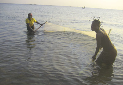 Women fish with a mosquito net, a practice that has contributed to overfishing.