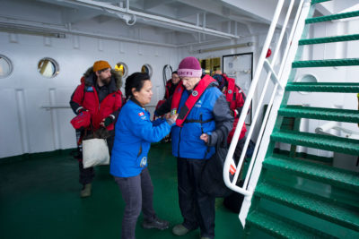Akademik Ioffe passengers put on life jackets as they prepare to board the Zodiac rescue boats.