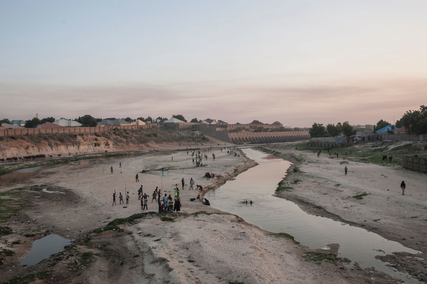 People in the northern Nigerian city of Maiduguri gather along the seasonal Ngadda River, which feeds into Lake Chad.Â 
  