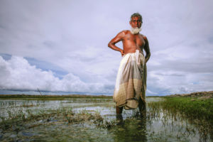 Farmer Abdul Majed was forced to switch from growing rice to raising shrimp after saltwater intruded into his paddies in Khulna, Bangladesh. 