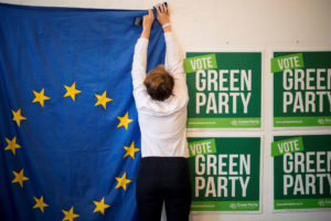 A volunteer hangs a European Union flag at a Green Party campaign office in London last month.