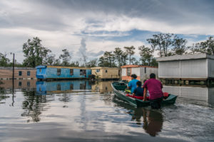 A family heads back to their home in Barataria, Louisiana after Hurricane Ida on August 31, 2021.