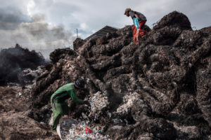 Workers prepare to burn plastic waste at an import dump in Mojokerto, Indonesia in 2018.