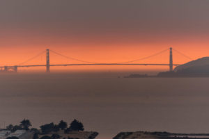 Smoke from wildfires creates an orange haze behind the Golden Gate Bridge in San Francisco.