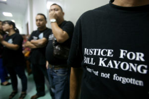 Supporters of Bill Kayong outside the court at the trial of three men charged in his murder. 