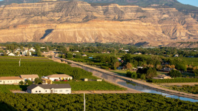 A canal managed by the Grand Valley Water Users Association carries water diverted from the Colorado River to peach orchards in Palisade, Colorado.