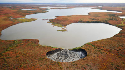 A permafrost slump, the size of a football stadium, on the shore of an unnamed lake in the Canadian Arctic.