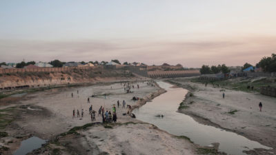 People in the northern Nigerian city of Maiduguri gather along the seasonal Ngadda River, which feeds into Lake Chad. 
  