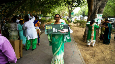 Women demonstrators protest a plan to to cut down more than 14,000 trees for a redevelopment project in New Delhi in June 2018.