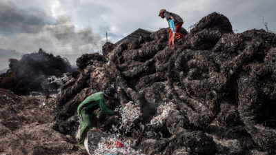 Workers prepare to burn plastic waste at an import dump in Mojokerto, Indonesia in 2018.