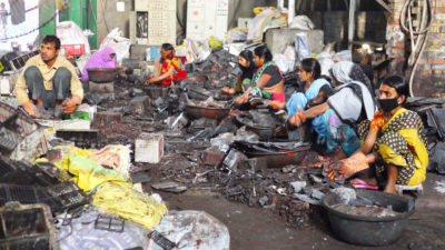 Workers dismantle car batteries in preparation for lead recycling in Patna, India.