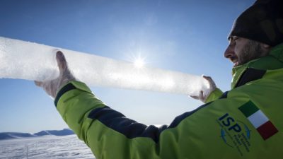 Researcher Andrea Spolaor holds an ice core recovered in Svalbard, Norway in April 2023.