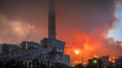 Wildfires rage behind a coal-fired power plant in Mugla, Turkey on August 4.
