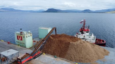 At the startup Running Tide's facility in Iceland, wood chips are loaded onto a barge for disposal at sea.