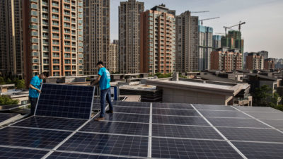 Workers install rooftop solar in the Chinese city of Wuhan, which has joined with cities across the globe to fight climate change.