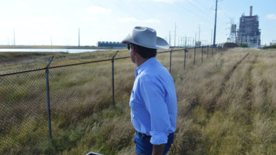 Jason Peeler looks out onto the San Miguel coal-fired power plant from his ranch in Christine, Texas.