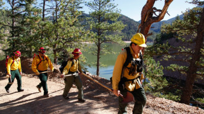 A fire crew hikes past McClure Reservoir in New Mexico en route to conducting a prescribed burn.
