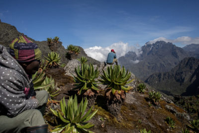 Kule (left) and guide Enock Bwambale pause at the Bamwanjarra Pass before heading on to Mount Stanley.