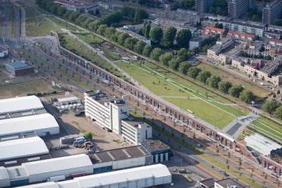A multifunction dike in Rotterdam that serves as both a dike and commercial shopping area. Below the dike’s grass-covered surface are shops that would be flooded if storm surges reach extreme levels.