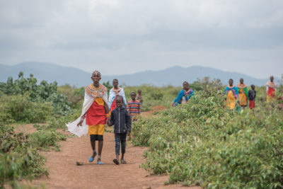 Samburu women and their children walking near Kirisia forest.