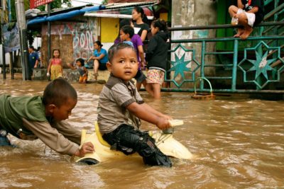 Children play in floodwaters after torrential rains in South Jakarta, Indonesia, January 17, 2013.