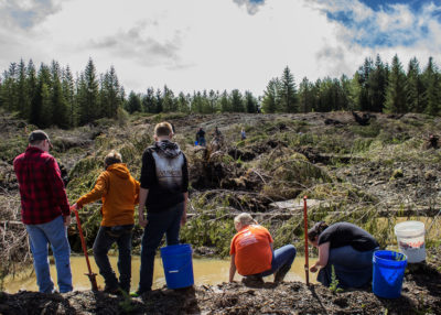 West Virginia schoolchildren examine a newly created vernal pond on Cheat Mountain, meant to attract wildlife and filter runoff. Chris Barton (right), co-founder of Green Forests Work, at the Cheat Mountain mine site.