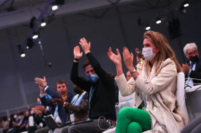 Delegates applaud at the conclusion of the Glasgow climate conference.