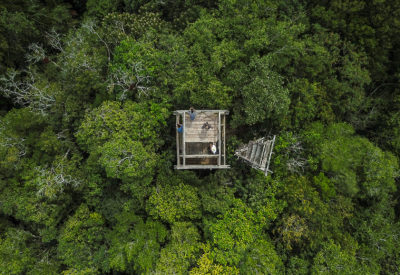 An aerial view of an observation tower used by Indigenous Uaxactun in Guatemala to keep watch over their forest. 