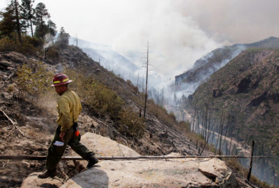 A firefighter above Los Alamos Canyon during the Las Conchas fire in July 2011. At its peak, the blaze consumed nearly an acre of forest per second.