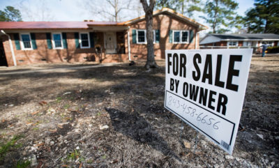 A for-sale sign in the front yard of a home damaged by flooding from Hurricane Florence in Conway, South Carolina in February 2019.