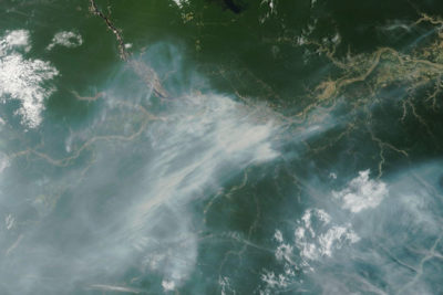 Smoke from wildfires along the Amazon River near the Brazilian city of Manaus in October. With Brazil and Colombia stepping up enforcement, forest loss is down significantly in the Amazon this year. But the region is also undergoing its worst drought in decades, causing the number of wildfires to spike.