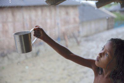 A girl collects rain, the main source of drinking water in Shyamnagar, Bangladesh, where waters are highly saline.